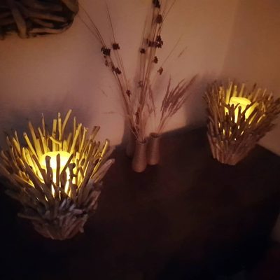 Pair of driftwood candle holders at night